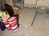 a box of paint sitting on the floor next to a box of paint