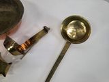 two spoons and a ladle sitting on a table