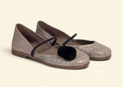 silver glitter ballerinas with black pom pom on the toe