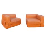 pair of orange leather lounge chairs on a white background