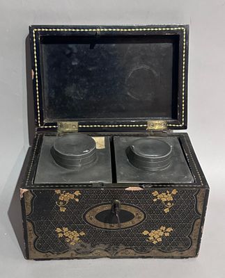 a black and gold box with two cups inside of it