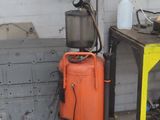 an orange suitcase sitting on the floor next to a yellow table