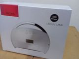 packaging of a white box with a clock on it sitting on a table