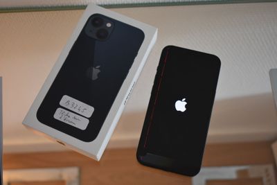 a box with an apple phone next to a box with an iphone on it