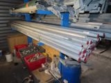 some metal pipes are stacked on top of each other in a garage