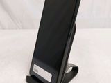 a cell phone that is on a stand on a table