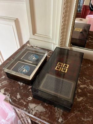 two books sitting on a marble table next to a mirror