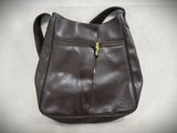 the brown purse is sitting on a white surface