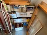 a closet with a lot of books on the shelves