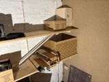 a shelf that has boxes on it and a laptop on it