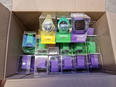 a box full of different colored watches in it
