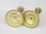 pair of antique brass candlesticks on a white background