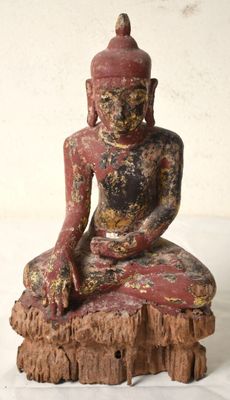 an image of a statue of a person sitting on top of a tree stump