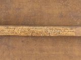 a piece of wood with writing on it on a table