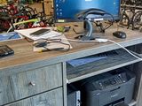 a desk with a computer and printer on it in a store