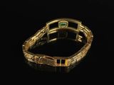 an image of a close up of a bracelet with a green stone