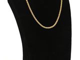 a black mannequin with a gold chain on a white background
