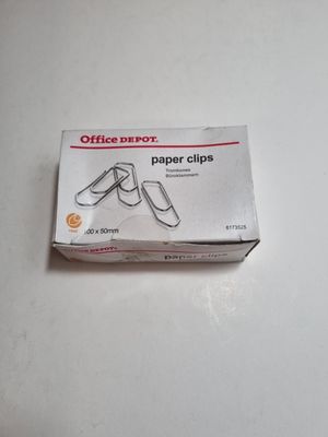a box of office paper clips sitting on a table