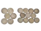 two pieces of old coins sitting on top of a white surface