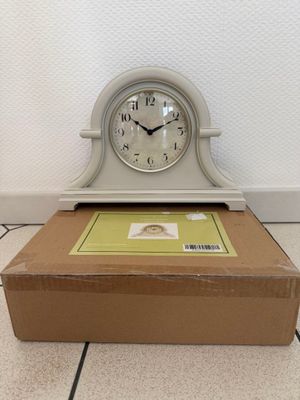 a clock sitting on top of a box on the floor