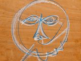 dessin représentant le visage d'un homme sur un morceau de bois, une cigarette à la bouche