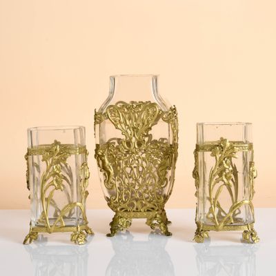 three glass vases sitting next to each other on a table