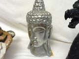 three statues of buddhas and a statue of a lion