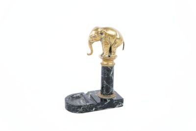 a statue of an elephant on a marble base