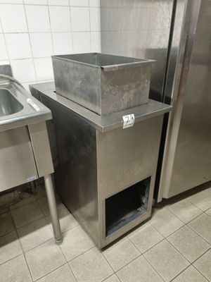 two stainless steel sinks and a refrigerator in a kitchen