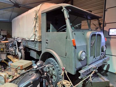 a military truck that is parked in a garage