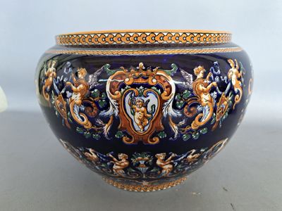 a large blue vase with a gold decoration on it