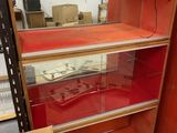 a display case with a guitar in it in a room