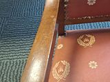 a red chair with gold designs on it in a room