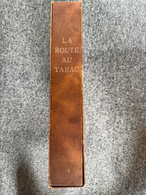 a brown book sitting on top of a gray blanket
