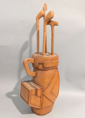 une sculpture en argile représentant un sac de golf et un sac contenant des clubs de golf