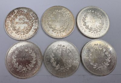 six different types of silver coins on a white surface