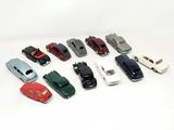 several toy cars are lined up in a row on a white surface