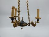 a chandelier with three candles hanging from it