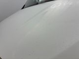 a white car that has a lot of scratches on the hood