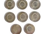 six different types of coins are shown on a white surface