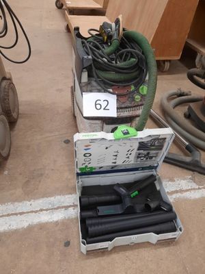 a box of tools sitting on the floor next to a machine