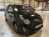 a picture of a small black car in a garage