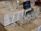 boxes of wine glasses are stacked on a table in a store