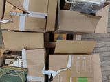 a pile of boxes on the floor next to a pile of books