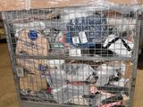 a metal cart with many items in it in a warehouse