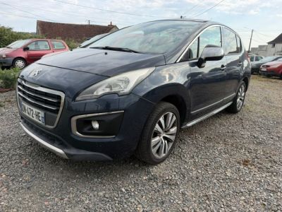 the small blue car is parked in a gravel lot