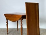 a small wooden table with a drop leaf on it