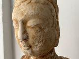 a small statue of a woman sitting on a table