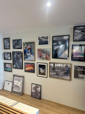 a picture of a living room with a lot of pictures on the wall