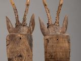 three pieces of wood with antelope heads on them on a table